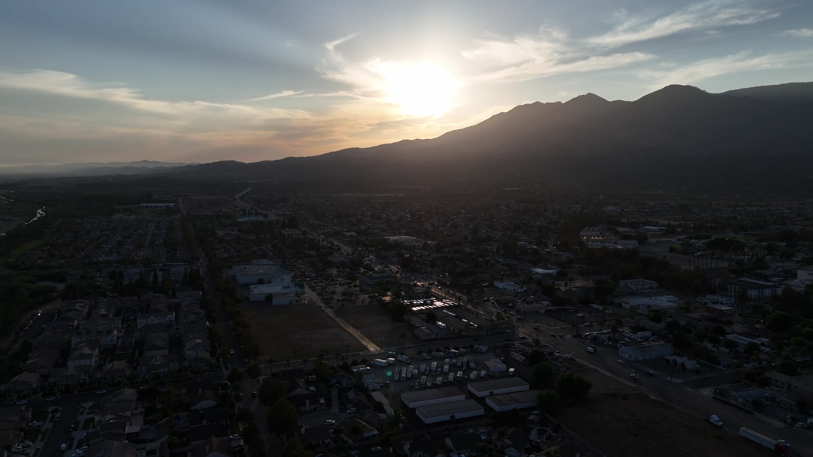 Warm aerial view across a residential neighborhood at golden hour