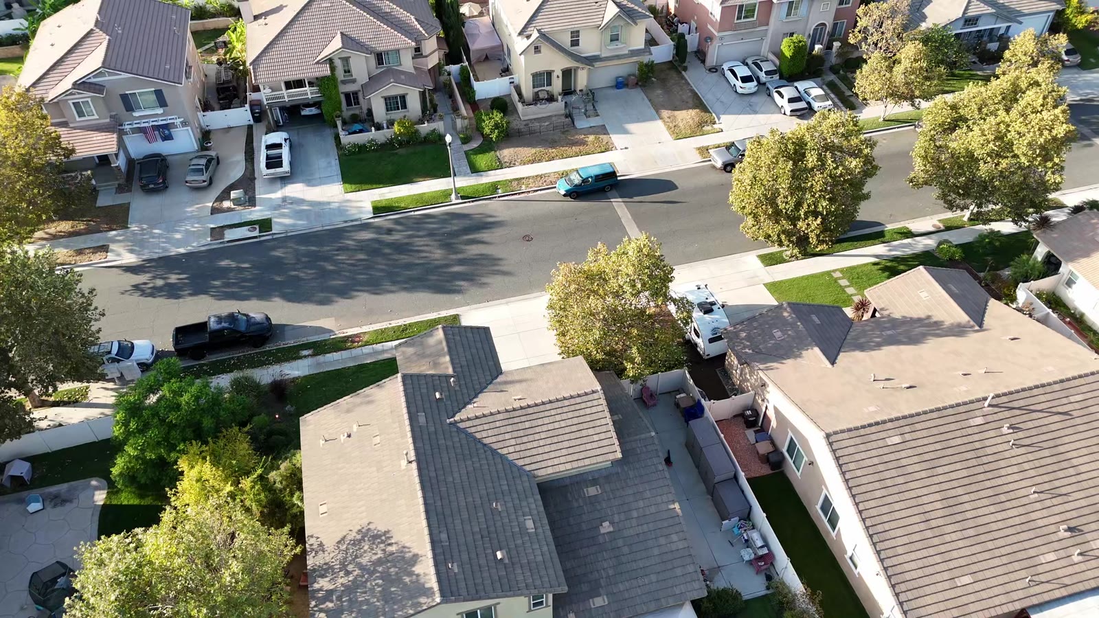 Aerial approach toward a Southern California neighborhood and mountains